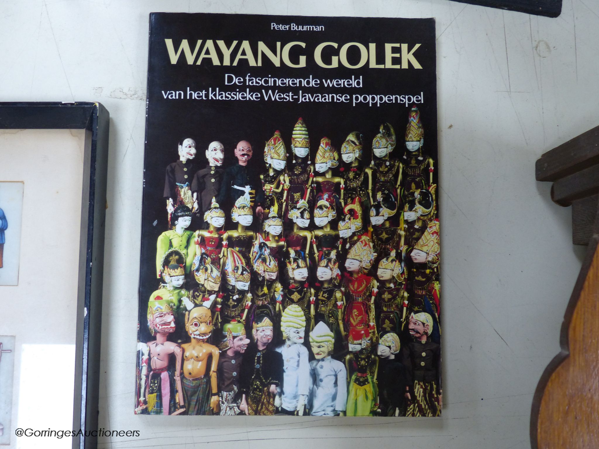 Two Indonesian stick puppets and a book relating to stick puppets, tallest 70cm
